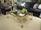 Acrylic waterfall coffee table with metal decor.